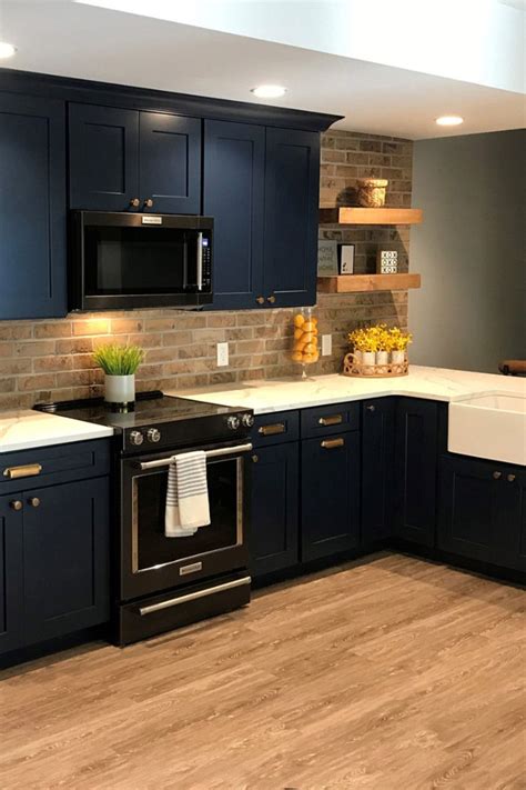 black stainless steel appliances with blue cabinets|kitchen with black and blue cabinet.